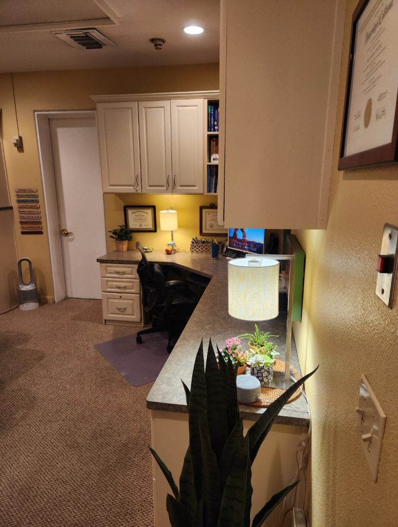 Mary's office desk, computer, plants